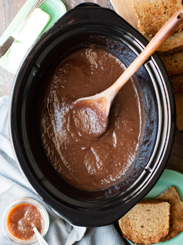 slow cooker half full of cooked apple butter