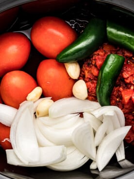 ingredients for salsa in a crockpot.